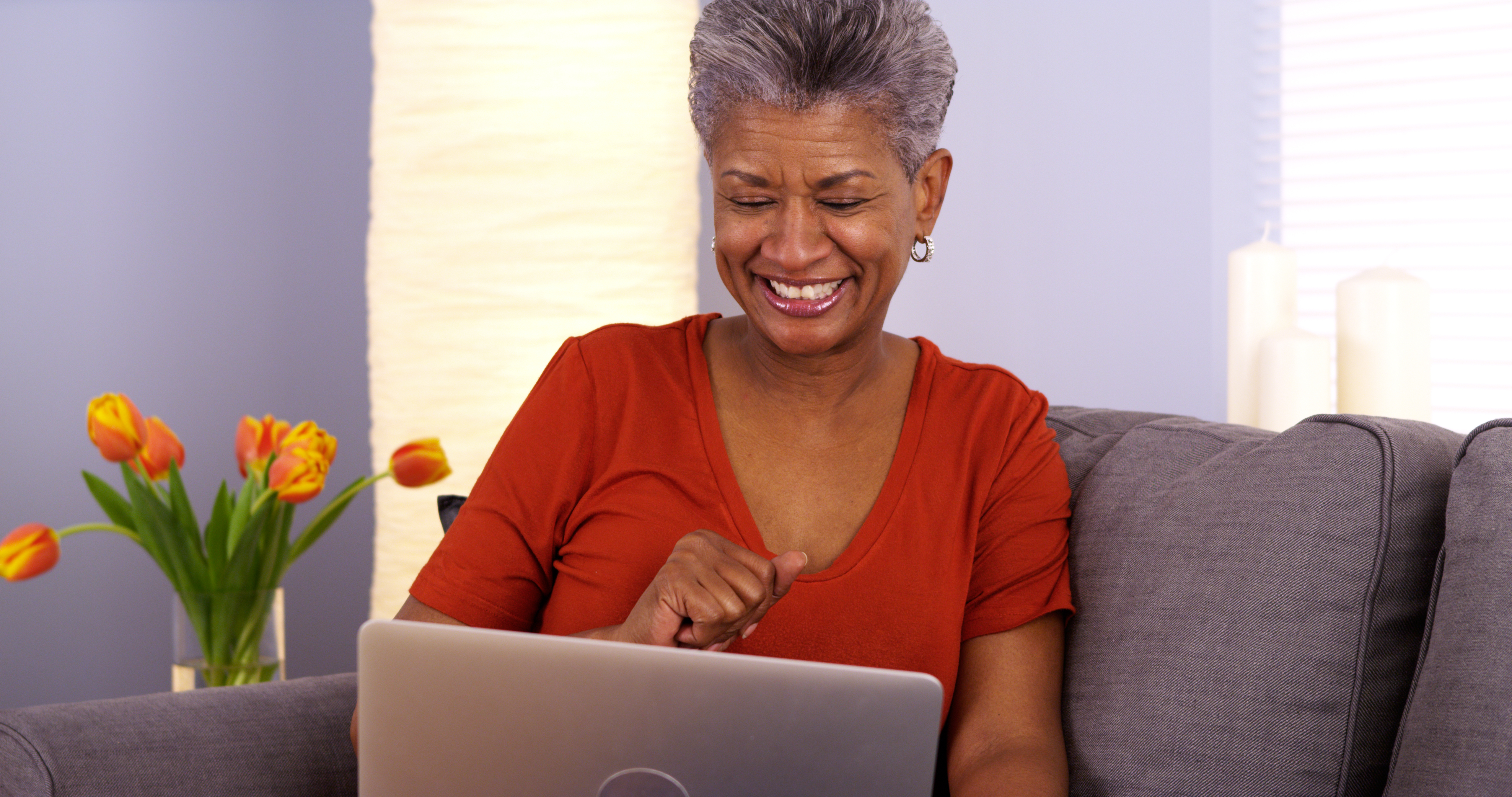 Senior woman smiling at laptop