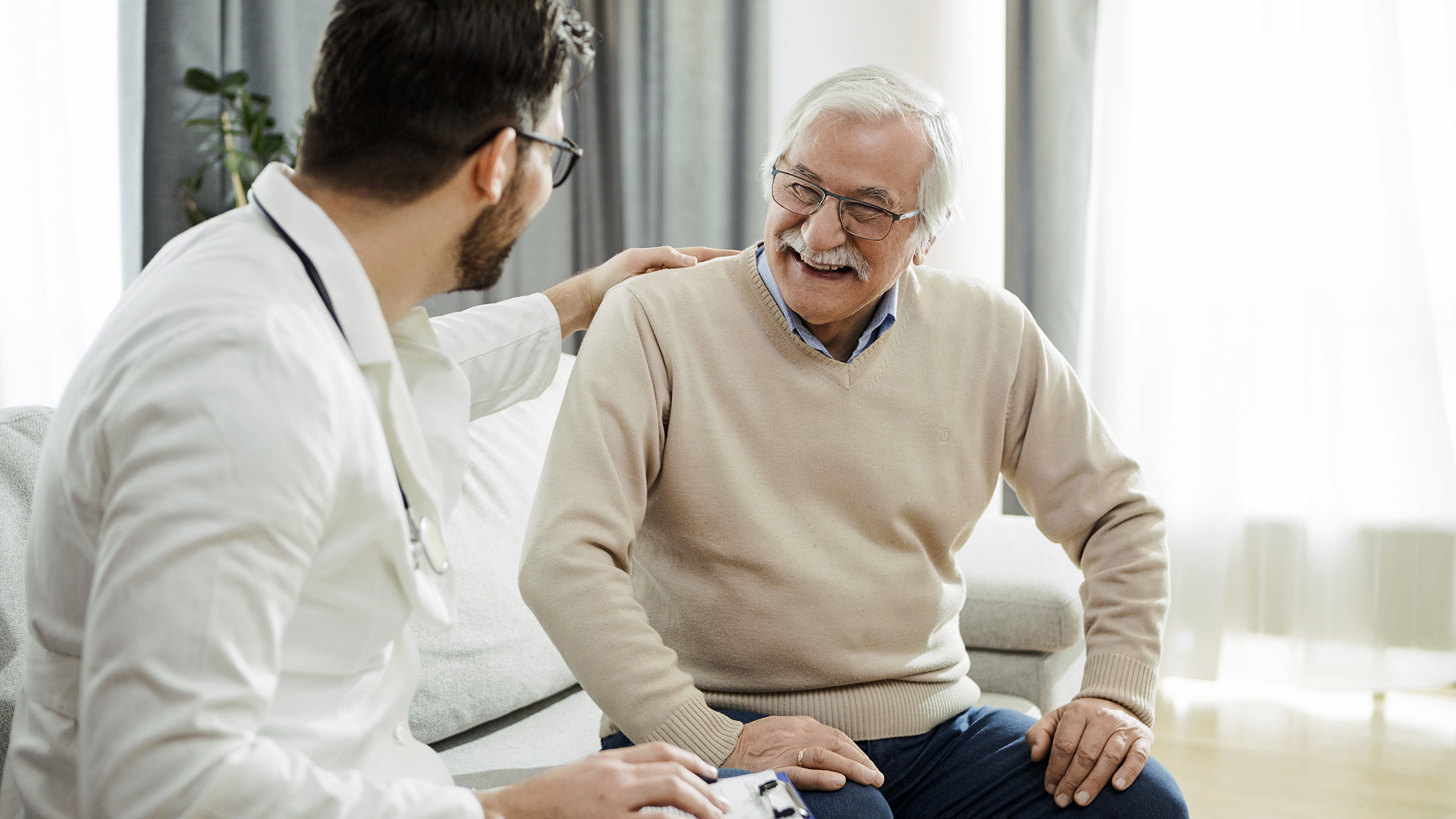 Senior man smiling with doctor