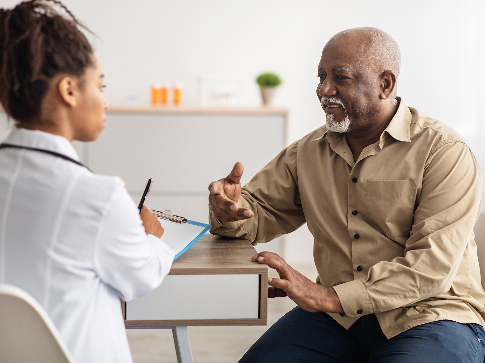 Senior man speaking with doctor.