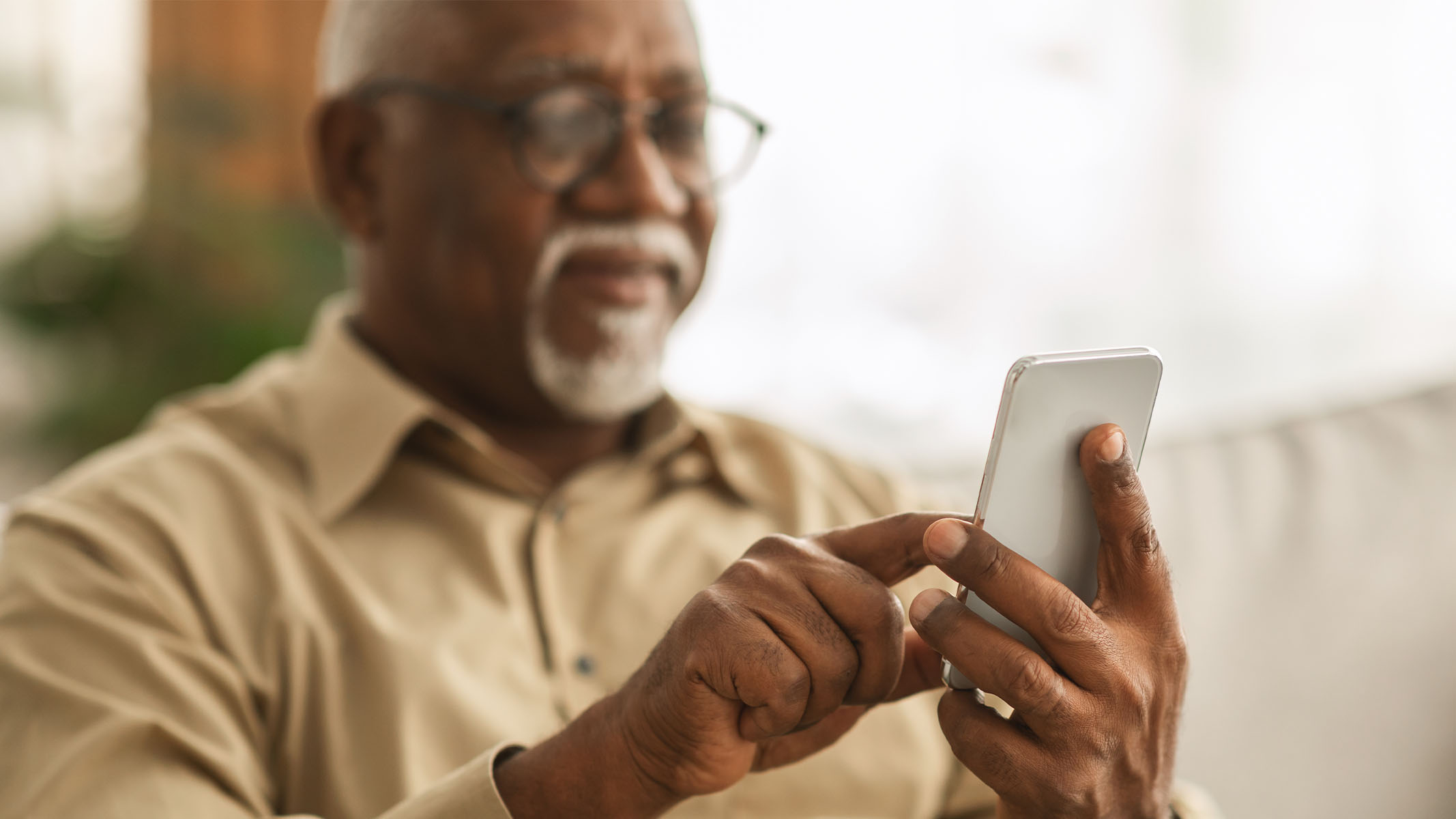 Senior man using smartphone.