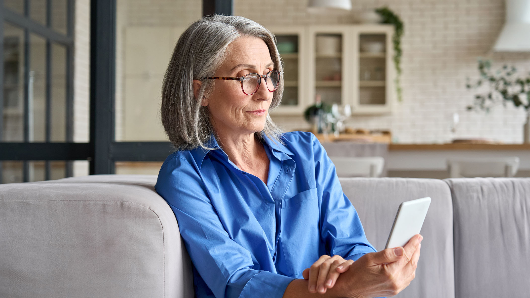 Senior woman looking at smartphone.