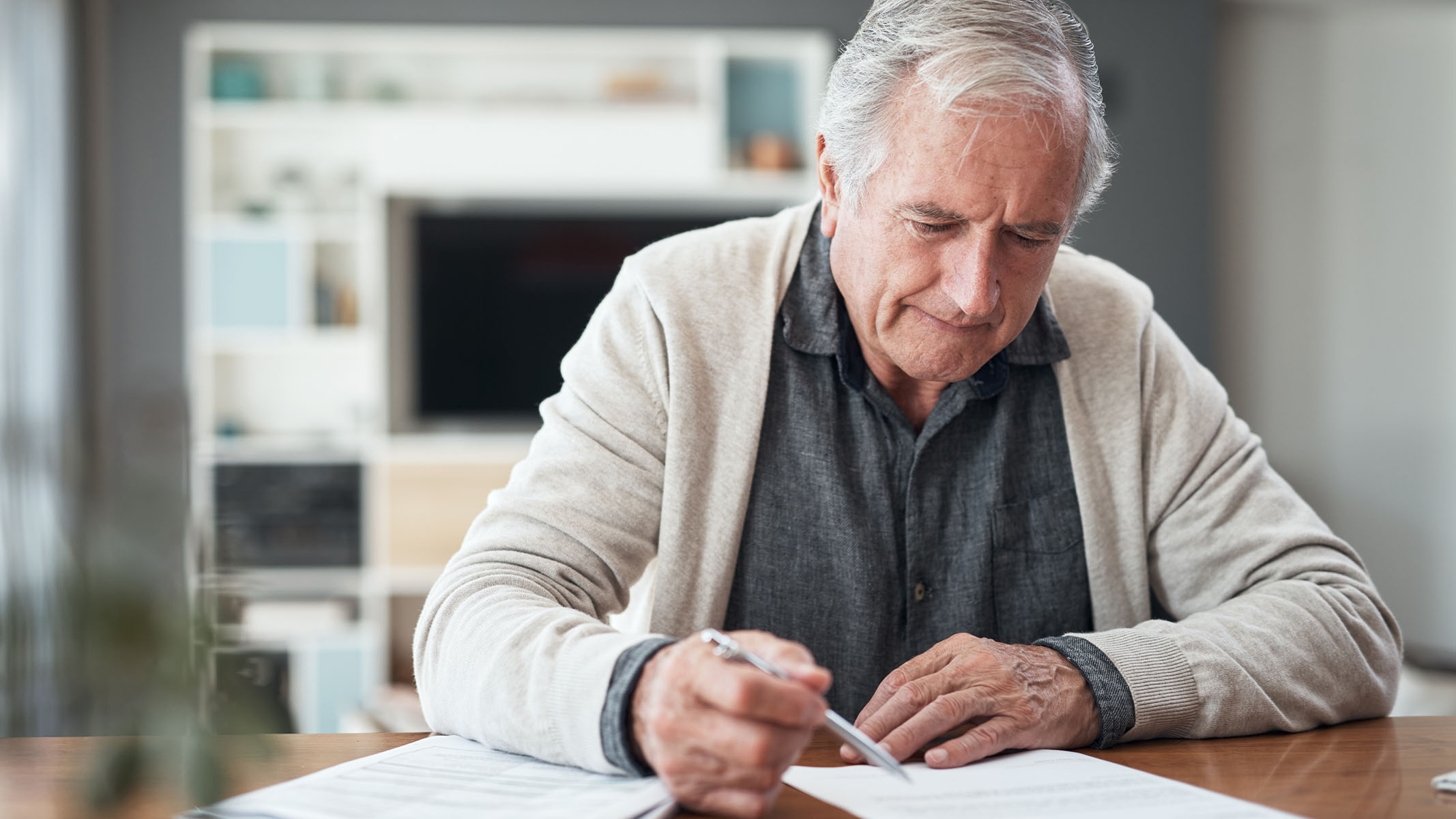 Senior man filling out form.    