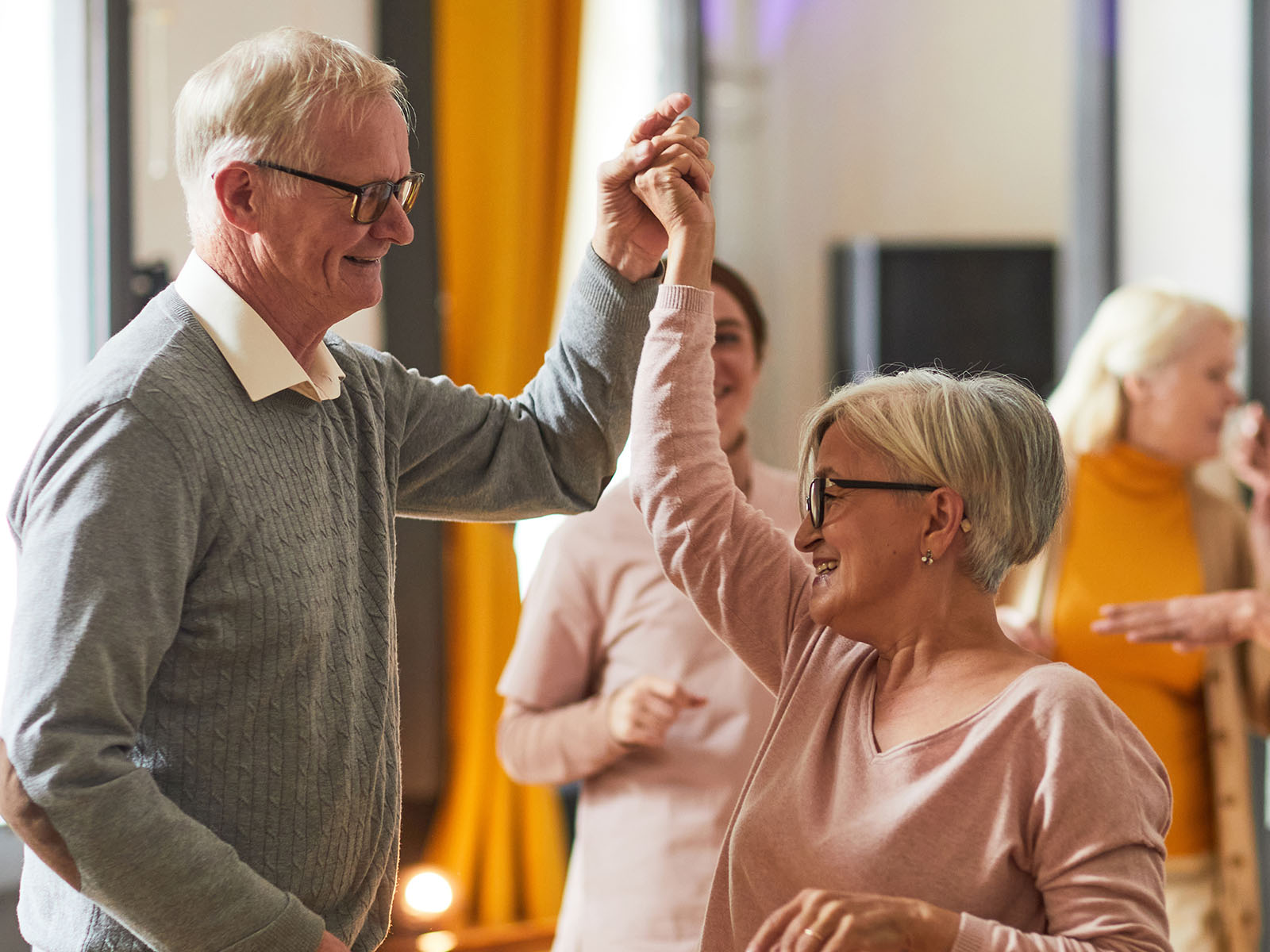  Group of smiling seniors dancing. 