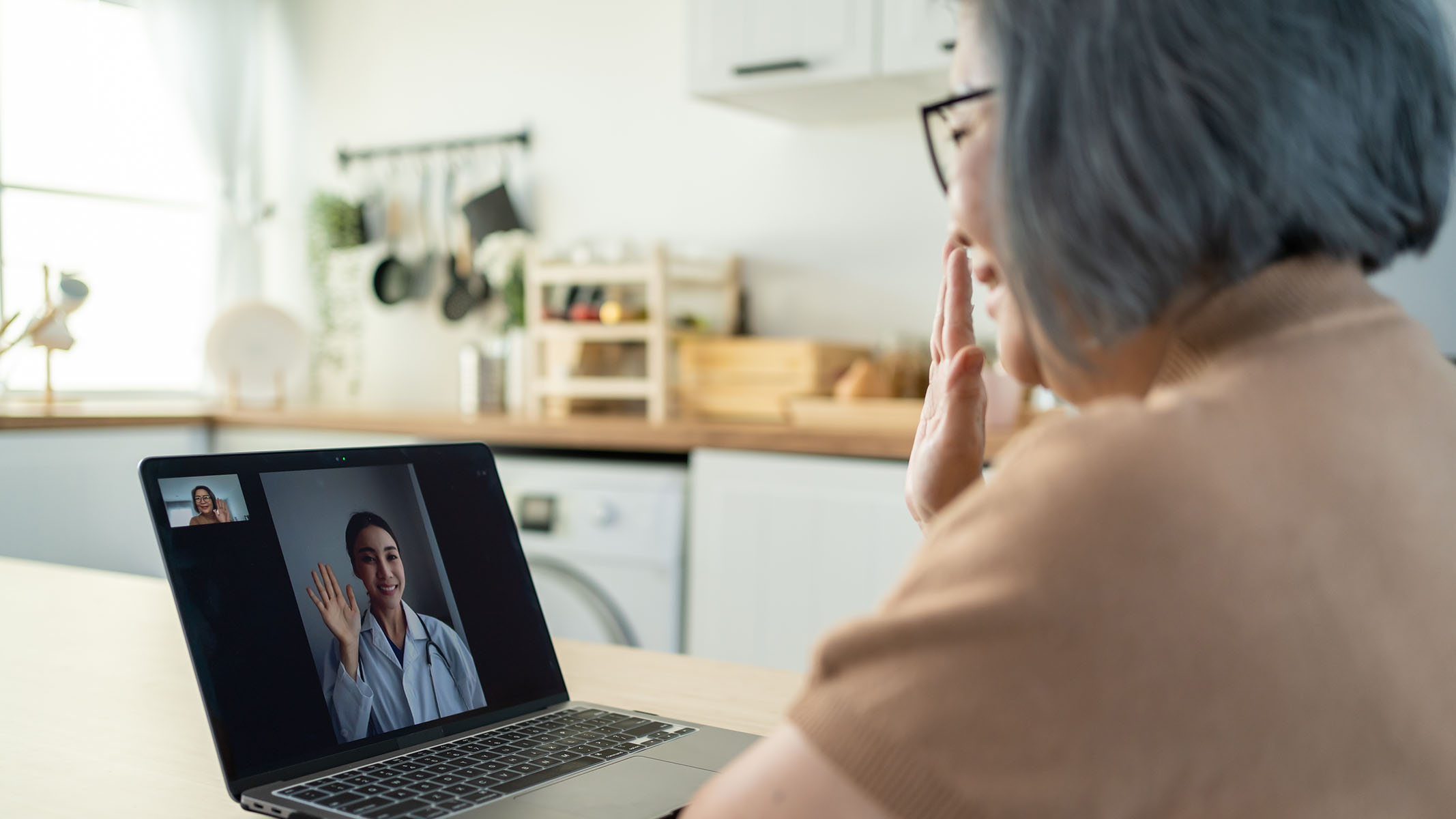 Senior woman on telehealth call with healthcare professional.